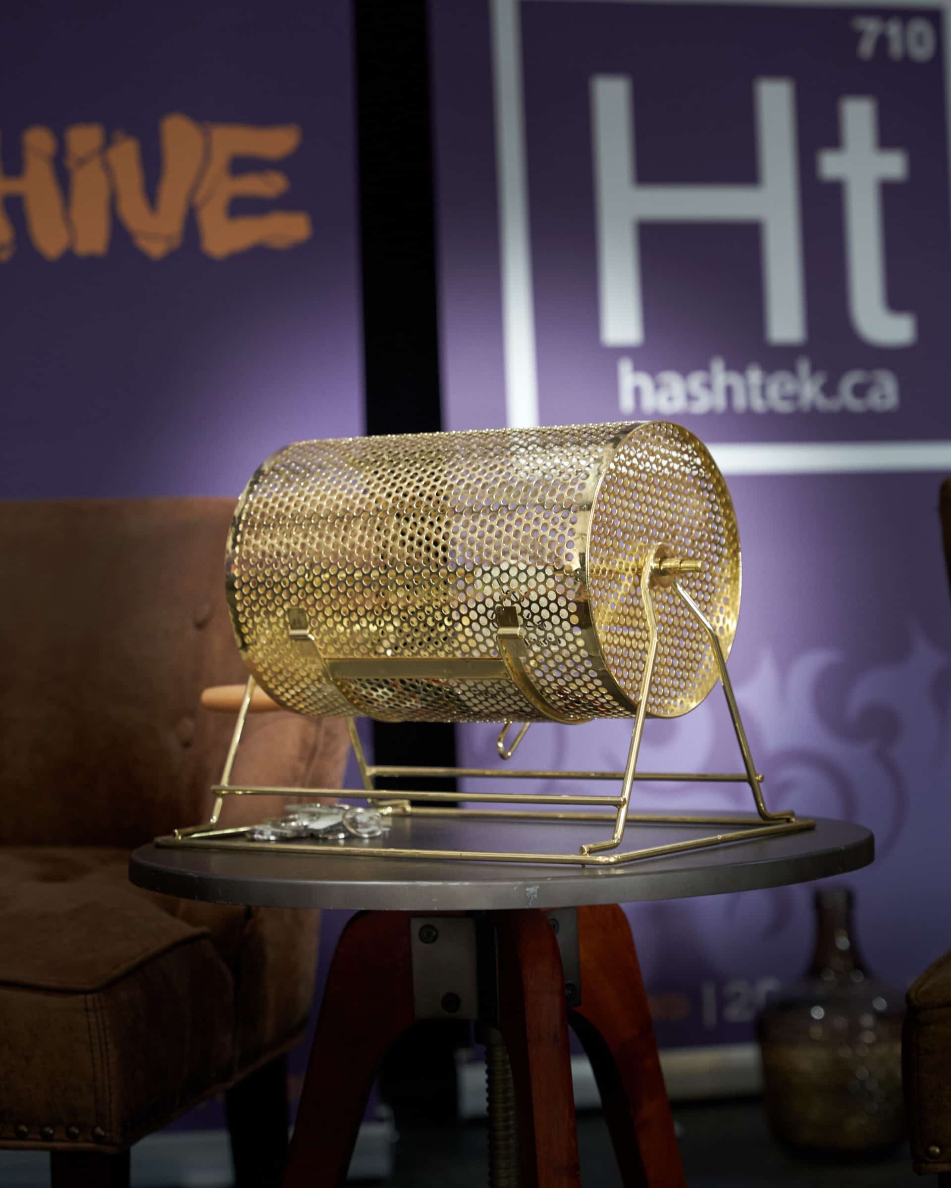 A gold trommel on the Hashtek backdrop at The Smoking Jacket 2023