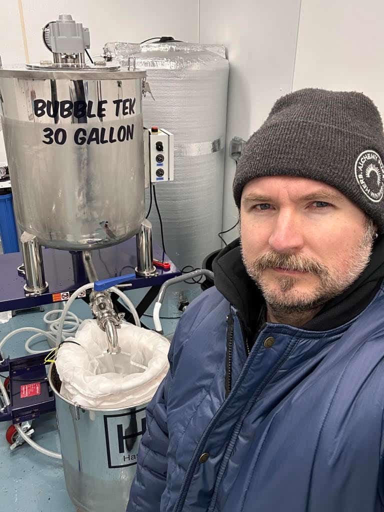 Jack Peele of Alchemy Pure beside a Hashtek 30 Gallon BubbleTek ice water extraction system